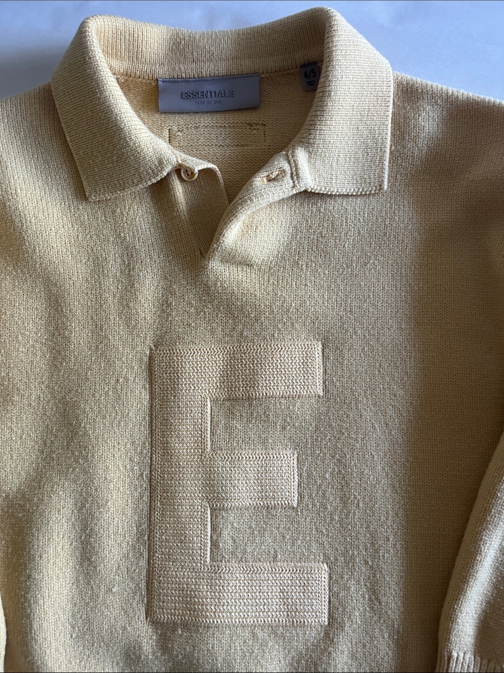 Essentials Kids Knit Polo in Cream with Embossed E Size 4/5
